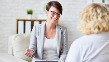 Successful psychologist talking to her patient